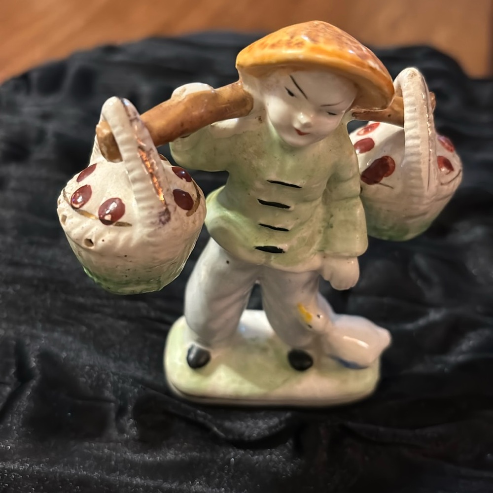 Chinese boy with goose figurine